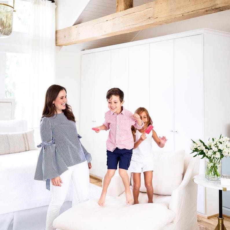 Interior designer, design blogger and influencer Marie Flanagan and her two kids enjoy a playful moment in her Crypton-centric room makeover.